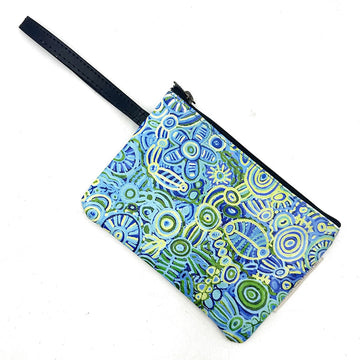 A cosmetic bag with a zip along the top and a wrist strap attached. The bag is printed with artwork by Cedric Varcoe.