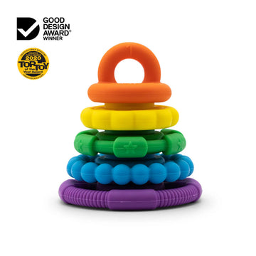 A stack of round silicone toys suitable for teething in rainbow colours.
