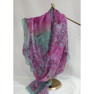 Pink and green patterned scarf on a gold hanger against a white background.