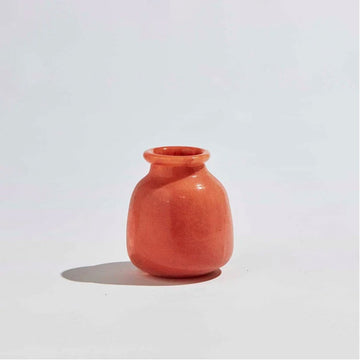 A short round vase in the shape of a jar with a smaller opening in an orange clay colour.