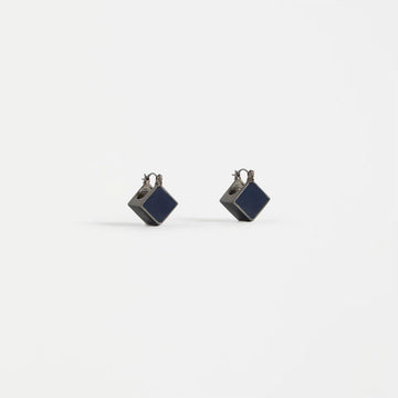 Pair of square earrings with blue centers on a white background.