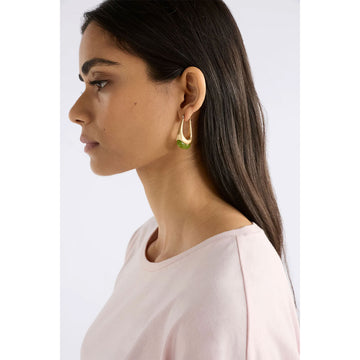 Gold hoop earrings with green accents on a light grey background.
