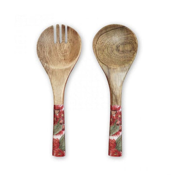 Wooden salad servers with floral handles on a white background.