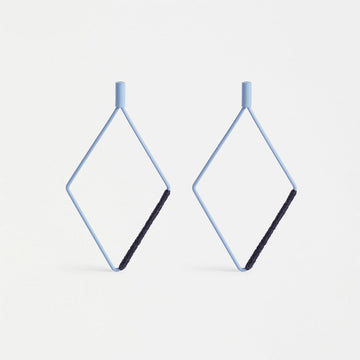A pair of drop earrings with a hollow diamond shape in ice blue with dark blue thread wrapped around one side.