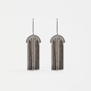 A pair of drop earrings with small black delicate chains hanging off an arch shape.