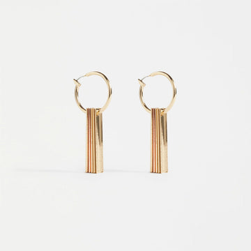 A pair of gold hoop earrings with five gold bars hanging off the hoops.