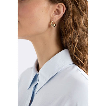 A pair of chunky silver hoop earrings.