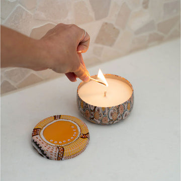 Decorative candle in a patterned tin with matching box on a white background.
