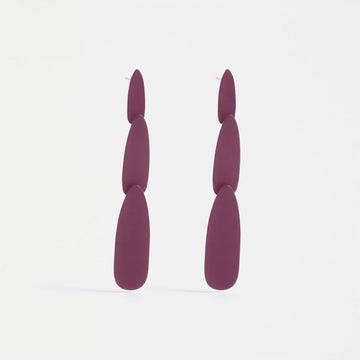 A pair of stud drop earrings featuring three different sized purple ovals.