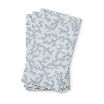 Folded paper napkins with a blue coral pattern on a white background.