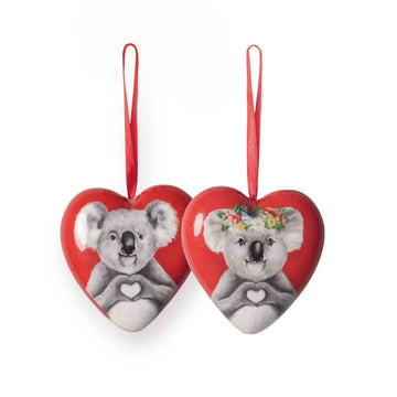 Two heart-shaped ornaments with koala designs on a white background.