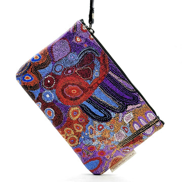A leather clutch purse with a zip along the top with a wrist strap attached. The front is printed with artwork by Andrea Adamson.