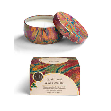 Colorful scented candle with packaging on a white background.