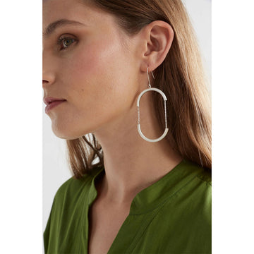 A pair of drop earrings in silver with the outline of an oval with chain details in the middle.