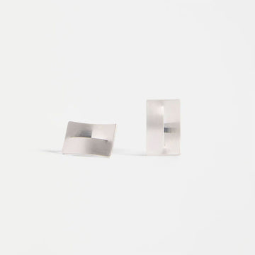 A pair of rectangle silver stud earrings.