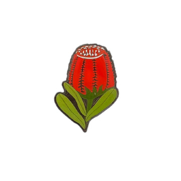 An enamel pin shaped like a banksia flower.