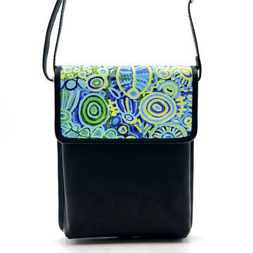 Front view of a black leather sling bag printed with artwork by Cedric Varcoe on the flap.
