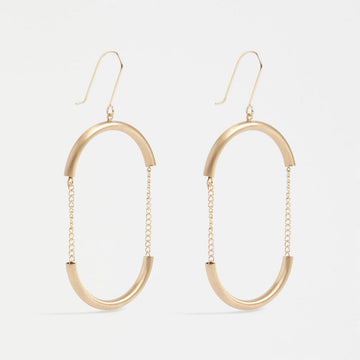 A pair of drop earrings in gold with the outline of an oval with chain details in the middle.