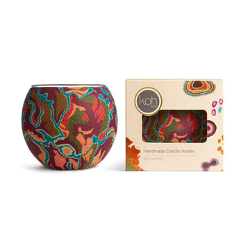 Colourful handcrafted candle holder with packaging on a white background