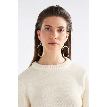 A pair of drop earrings in gold with the outline of an oval with chain details in the middle.