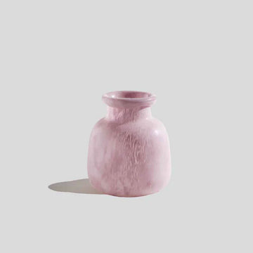 A short round vase in the shape of a jar with a smaller opening in a lilac colour.