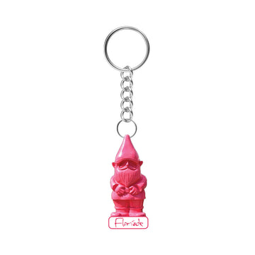 A keyring with a pink gnome charm hanging off the ring.