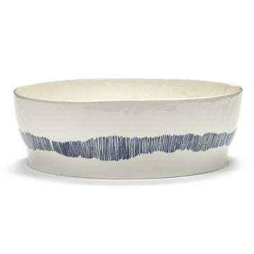 Side view of a ceramic bowl in white with blue stripes on the side.