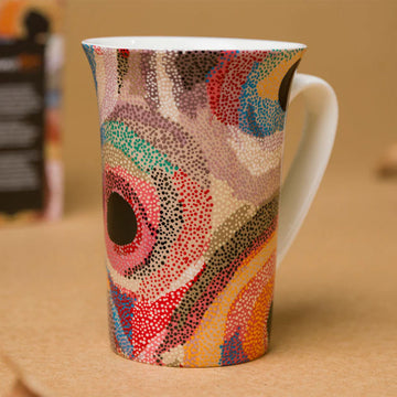 A ceramic mug printed with artwork by Marianne Burton.