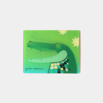A rectangle magnet with a moving image of a crocodile against a green background.