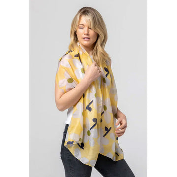 A silk scarf in lemon yellow illustrated with white flowers.