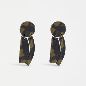 A pair of drop earrings made from wooden shapes printed with an olive green check pattern.