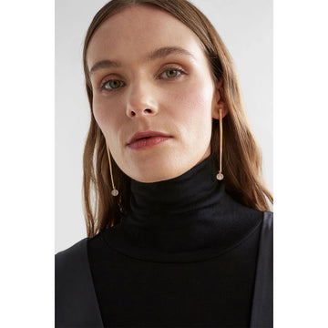 A pair of stud drop earrings with a long narrow bar in silver with a dark blue round bead on the end.