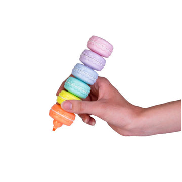 A person using stack able macaroon shaped highlighters.