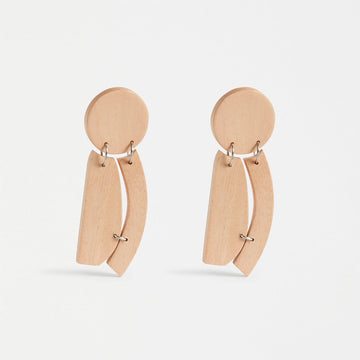 A pair of drop earrings made from wooden shaped linked together.