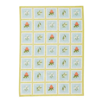 Tea towel with floral grid pattern on a light blue background.