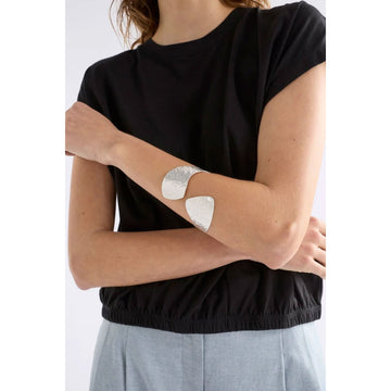 A gold bangle on a white background.