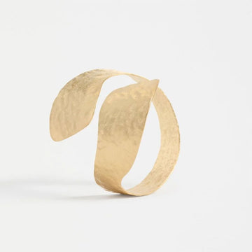 A gold bangle on a white background.