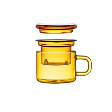 Amber-colored glass mug with a matching lid on a beige background.