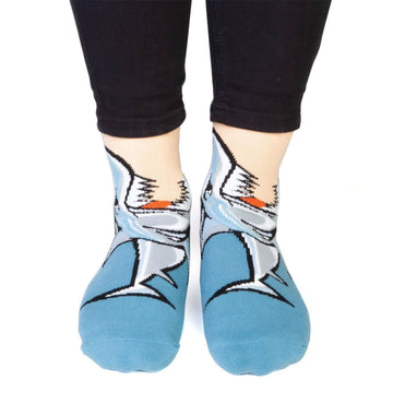 Close up of a person wearing socks printed with an image of a shark.
