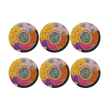 Six round glass coasters printed with artwork by Ruth Stewart.