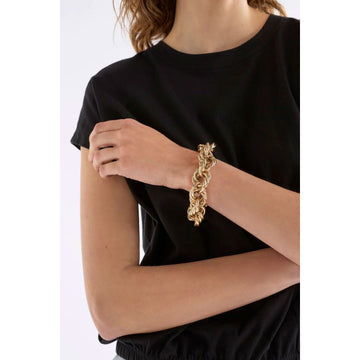 A gold bracelet made up of lots of chains on a white background.