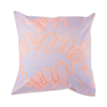 A European cushion pictured printed with purple and orange Indigenous artwork.