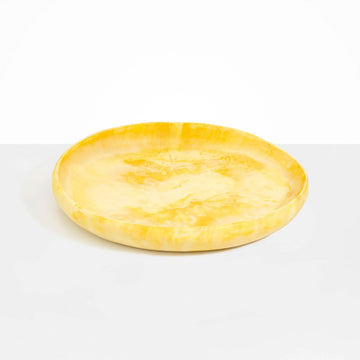 A large shallow bowl made from yellow resin.