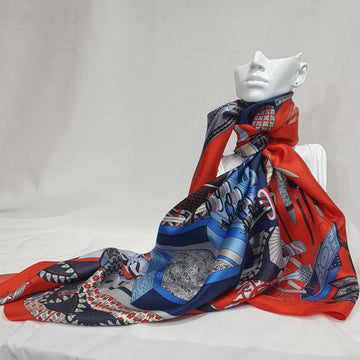 Colorful fabric with a detailed design of tools, flowers, and patterns on a red background.