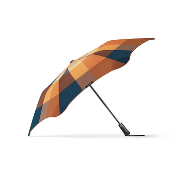 An open umbrella printed with a checkered pattern in orange, dark blue and brown.