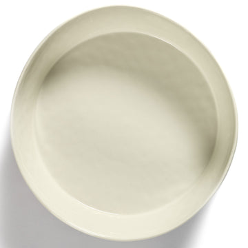Side view of a ceramic bowl in white with blue stripes on the side.