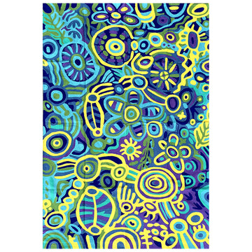 A rug is laying flat and printed with artwork by Cedric Varcoe in yellow, blue and green.