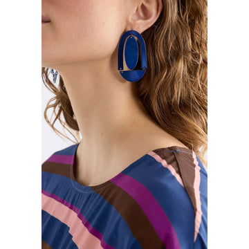 A pair of stud earrings with a large arch and circle shape in blue.