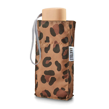 A folded up umbrella in a square shaped pouch with leopard print.
