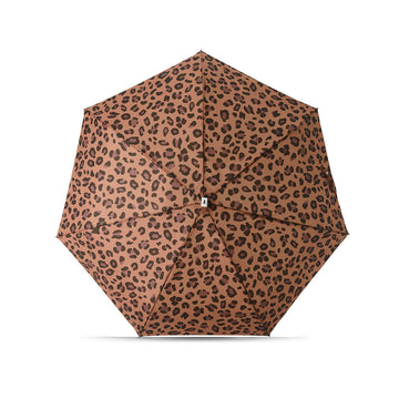 A folded up umbrella in a square shaped pouch with leopard print.